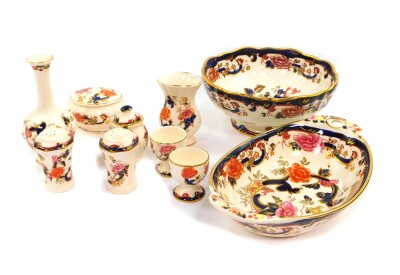 A group of Masons Ironstone decorated in the Mandalay pattern, comprising a twin handled oval dish, fluted circular pedestal fruit bowl, two vases, trinket box and cover, a pair of egg cups and a three piece cruet. (10)