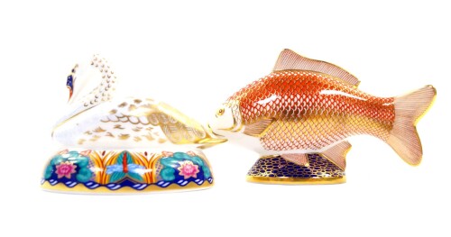 A Royal Crown Derby porcelain imari paperweight modelled as a Golden Carp, and another modelled as a swan nesting, both seconds. (2)