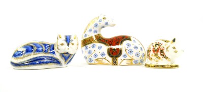 A Royal Crown Derby imari porcelain paperweight modelled as a horse, in recumbent pose, another modelled as an Arctic Fox, and a third as a piglet, all seconds. (3)