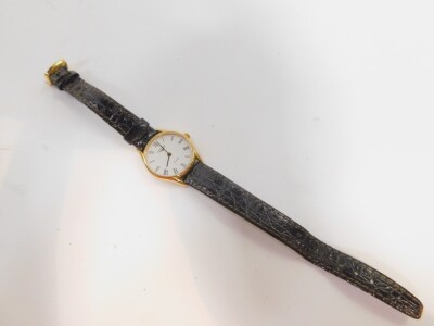 A Longines lady's gold plated cased wristwatch, circular white dial bearing Roman numerals, stainless steel back, numbering 25802382, on a leather strap. - 2