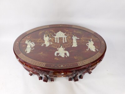 A Chinese red lacquer and 'Shibyama' oval coffee table, decorated with figures and pagodas in a garden setting, raised on six tapering square legs and lion's paw feet, 52cm high, 120cm wide, 77cm deep., together with a Chinese red lacquer and Shibyama set - 2