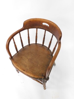 A Victorian oak captain's chair, with a screw down solid seat, raised on turned legs united by turned stretchers. - 2