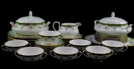 A Royal Doulton porcelain part dinner service decorated in the Ashmont pattern, comprising an oval meat platter, a pair of vegetable tureens and covers, soup tureen cover, gravy boat on stand, eight dinner and dessert plates, and side plates, seven soup c