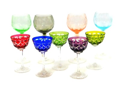 A group of Continental harlequin coloured glassware, comprising four stemmed wine glasses, engraved with berries and leaves, and five stemmed dessert wine glasses. (9)