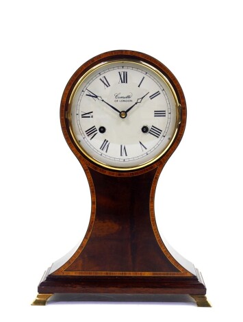 A mahogany and satinwood cross banded balloon mantel clock, by Comitti of London, cream metal dial bearing Roman numerals, clockwork movement with bell strike, the case of conventional form, raised on four brass bracket feet, with key, 30.5cm high.