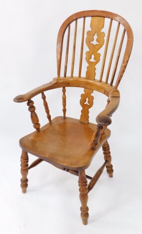 A Victorian oak yew and beech Windsor chair, solid saddle seat raised on turned legs, united by an H framed stretcher.