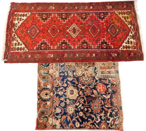 A Shiraz runner, red ground decorated with five lozenges, floral and other motifs, 190cm x 103cm , together with a Persian rug, decorated with flowers against a blue ground, 106cm x 91cm. (2, AF)