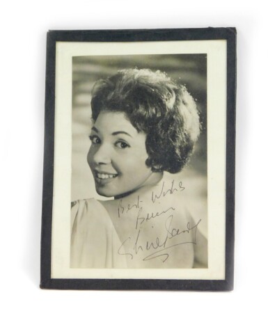 A signed photograph of Shirley Bassey, dedicated 'Best Wishes Brian', 15cm high, 11cm wide.