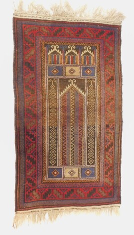 A Kurdish prayer rug, brown ground with geometric borders, 134cm x 81cm.