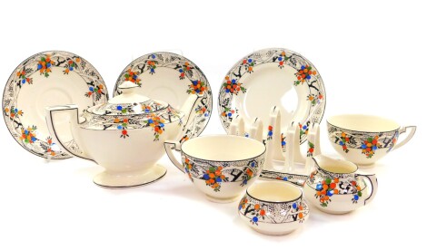 A Crown Ducal pottery breakfast set for two decorated in the Acacia pattern, No A1699, comprising teapot, cream jug and sugar bowl, four division toast rack, a pair of teacups and saucers and a biscuit plate.