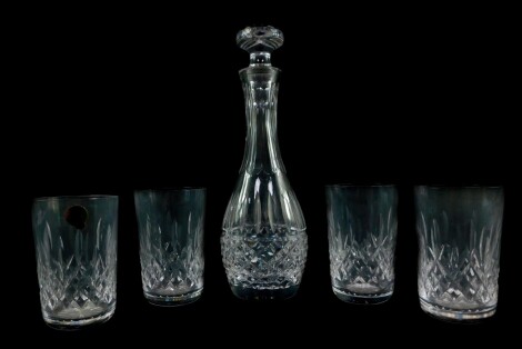 A Waterford Crystal decanter and stopper decorated in the Lismore pattern, 27.5cm high, together with four Lismore pattern tumblers. (5)