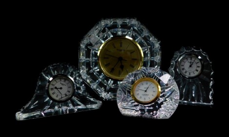 A Waterford Crystal mantel clock, of octagonal form, 13cm diameter, together with three Waterford Crystal bedside clocks. (4)