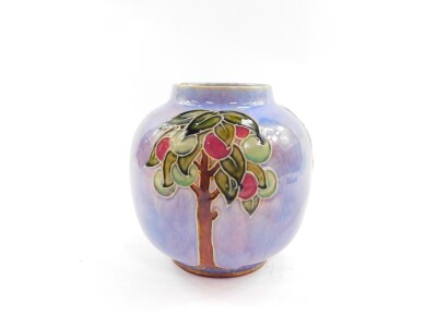 A Royal Doulton stoneware vase, moulded with fruit trees against a lilac and pink ground, No 8680F, impressed marks, 15cm high. (AF)