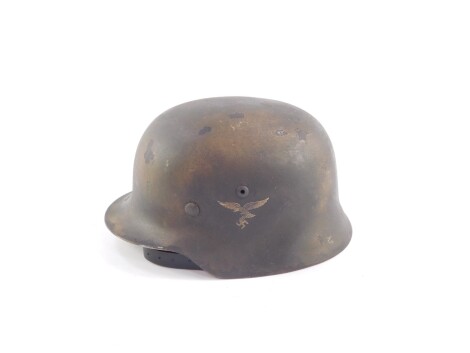 A copy of a German WWII Luftwaffe helmet, Type M35/40, with decal to left side, leather interior and chin strap stamped Larsen, Berlin 1939. Auctioneer announce - description amended - helmet is a copy.