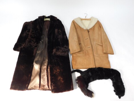 A lady's full length camel coat, with sheepskin lining, a faux fur full length coat, and a black Mink fur stole. (3)