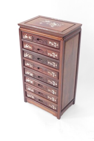 A Chinese hardwood and mother of pearl inlaid collector's chest, of eight drawers with bamboo and branch inlay, raised on square legs, 59.5cm high, 31.5cm wide, 20.5cm deep. (A/F)