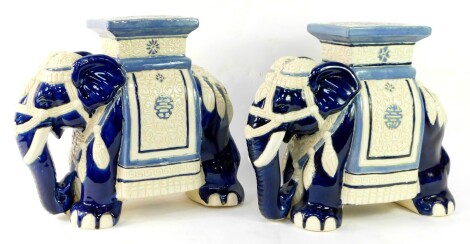 A pair of blue and white pottery garden seats modeled as elephants, in standing pose, 51cm wide.