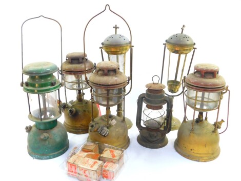 Four brass and enamel tilly lamps, smaller metal cased tilly type lamp, and a pair of brass gimbal candle lamps, possibly for burning church incense, together with assorted spares. (a quantity)