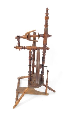 A Victorian oak and fruitwood spinning wheel, dated 1889 to the front, 83.5cm high.