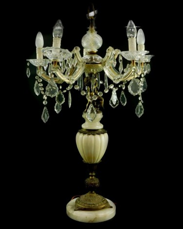 An Italian alabaster brass and cut glass five branch table lamp, with crystal drops and swags, the stem formed as a puto, raised on a semi-fluted urn stand, on a circular base, 88.5cm high. (AF) This lot contains untested or unsafe electrical items. It i