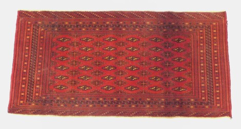 A Turkoman saddle bag rug, with multi borders and multi gull centre field, 134cm x 68cm.