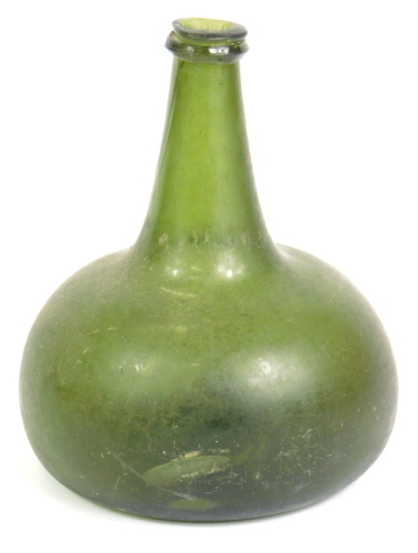 An 18thC green onion shaped glass wine bottle, with a tapering neck, 18cm high.