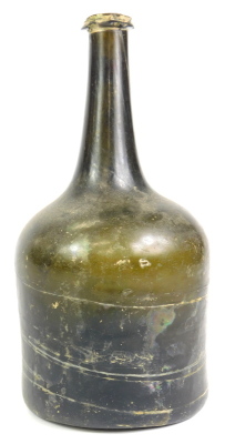 An 18thC green glass wine bottle, 23cm high.