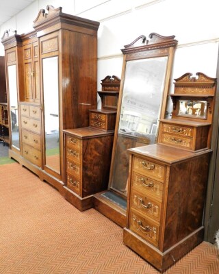 A late Victorian inlaid rosewood bedroom suite, with extensive marquetry in pearwood, satinwood and bone inlays, of a Neo Classical design, comprising wardrobe compactum with double swan necked hood, with dentil moulded cornice, inverted break front centr