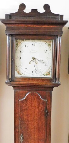 Cavit of Bedford. An early 19thC oak longcase clock, the square painted cream dial with floral decoration and an oak shaped pediment top case, 30 hour movement, with pendulum, 193cm high, 41cm wide, 22cm deep.