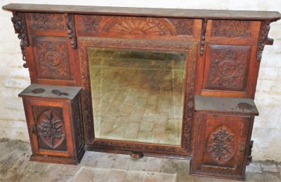 A carved oak overmantel, with central rectangular mirror frame and two cupboard doors, each with carved decoration, the top section 103cm high, 161cm wide, approx 32cm deep. - 2