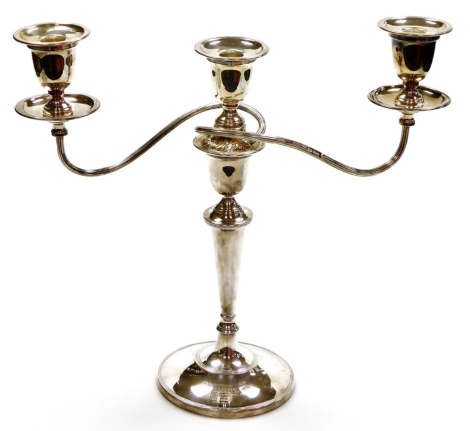 A George V silver candelabrum, presented to S H Spurling by the Directors of Courage Barclay and Simonds Ltd on Completion of 45 Years Service 1920-1953, the three branch candelabrum with lift off sconces, on a tapered and weighted stem base, Sheffield 19