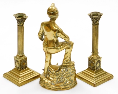 A pair of late 19thC brass Corinthian column candlesticks, 23cm high, and a cast brass figure of a Miner, 27cm high. (3) - 2