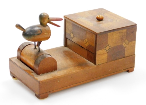 An early 20thC Japanese parquetry cigarette dispenser, with a bird picker, 18cm wide.