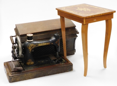 A marquetry sewing table, with musical lift top and a cased sewing machine (2).