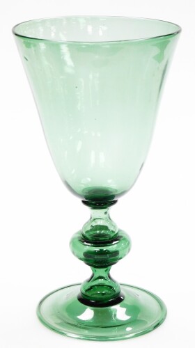 A Victorian green glass goblet vase, with flared rim on a stepped base, 34.5cm high, the bowl 18cm diameter.