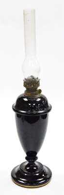 A Victorian opaque glass oil lamp, the oil lamp base on a black finish with painted detailing of blue leaves and flowers with a white stalk and gilt banded stepped base with detachable top oil lamp section, 50cm high. - 2