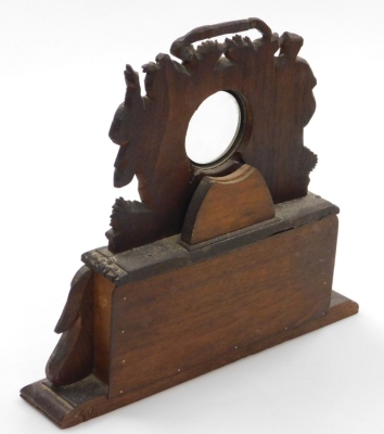 A continental carved wooden timepiece case, the top with central glass panelled section for either a clock or watch, with two gentleman to either side and a single cupboard door to base, 30cm high, 33cm wide, 6cm deep. - 2