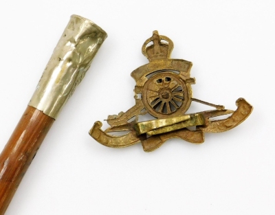 A Royal Engineers swagger stick and a Royal Artillery cap badge (2). - 2