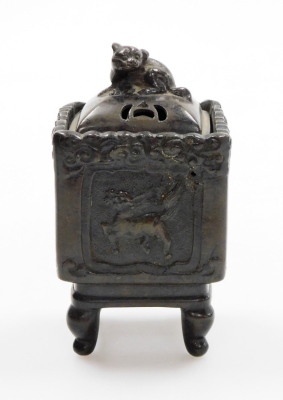 A group of Oriental ceramics, to include a miniature bronze censer with a Dog of Fo top, and dragon motifs character stamp to underside, 12cm high, a pair of glazed horses, 7.5cm high and a jade elephant on base (AF). (4) - 2