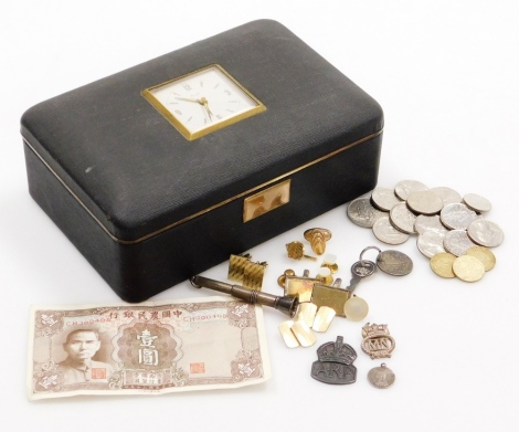 A vintage clock mounted travel case and contents, to include various one franc coins, tokens, shillings, silver pencil case, gold plated cuff links, etc. (a quantity)