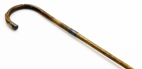 A silver handled walking cane, with single silver cap end and column, Birmingham assay hallmarks rubbed, on a wooden cane, 92cm long.