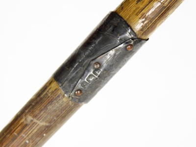 A silver handled walking cane, with single silver cap end and column, Birmingham assay hallmarks rubbed, on a wooden cane, 92cm long. - 2