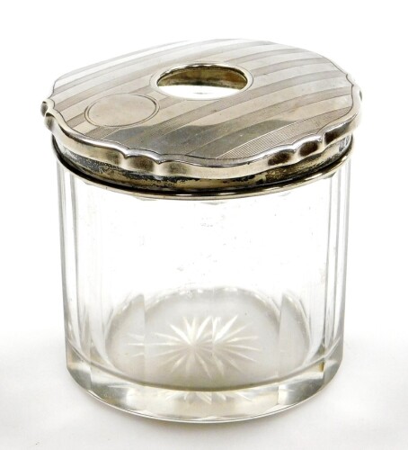 A George V silver topped dressing table jar, the engine turned design top Birmingham 1926, on a cut glass jar, 7cm high.