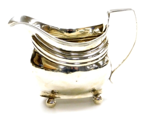 A George III silver sauce boat, part reeded body with reeded handle, bun feet, bearing the initials SEA, maker Peter & William Bateman, London 1793, 4oz.