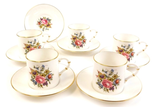 A part set of Royal Worcester coffee cans, comprising six saucers with gilt decoration and floral design together with five associated coffee cans.