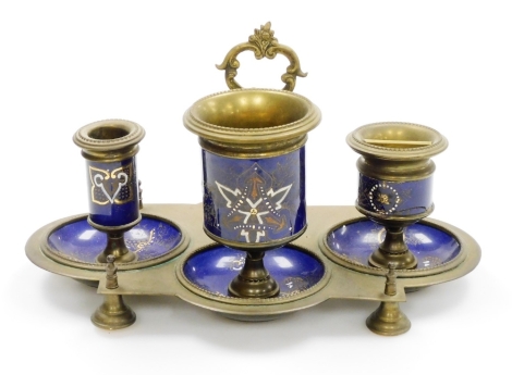 A continental brass and enamel ink stand, with blue enamel gilt and white applied decoration, 22cm high, 30cm wide, 20cm deep.