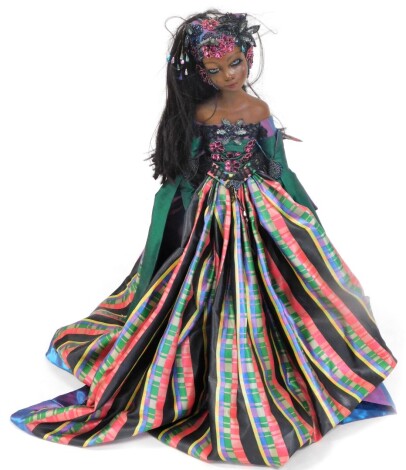 A large Europa limited edition doll, dated 2004 and numbered 43 of 500, in elaborate multi-coloured dress, with stand, 100cm high.