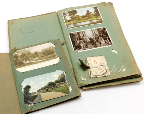 Two Edwardian postcard albums and contents, to include black and white and coloured postcards of city scenes. (2)