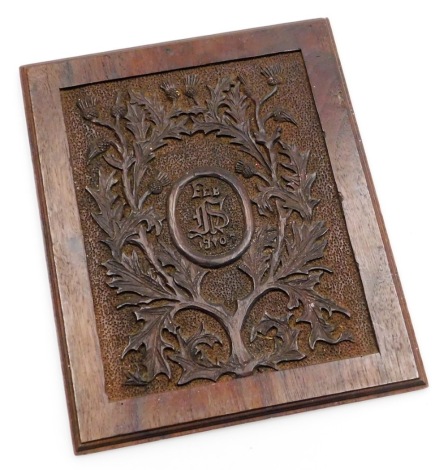 An early 20thC carved oak panel, with central crest stamped Feb 1907 and bearing the initials DS ? with a dandelion surround, 27cm x 23cm.