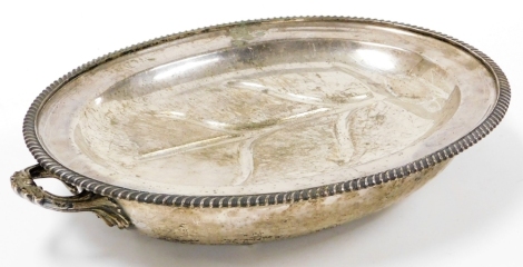 A silver plated turkey serving tray, with drainer and bottom section with scroll carved handles, 10cm high, 44cm wide, 35cm deep.